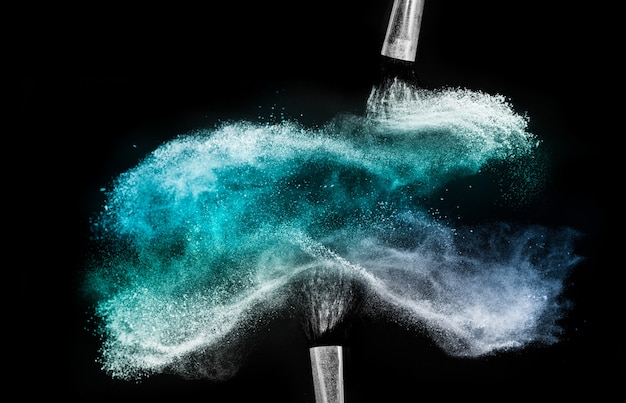 Cosmetic brush with blue cosmetic powder spreading