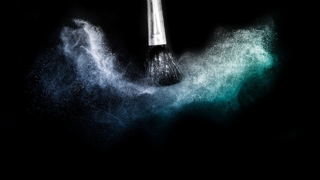 Cosmetic brush with blue cosmetic powder spreading