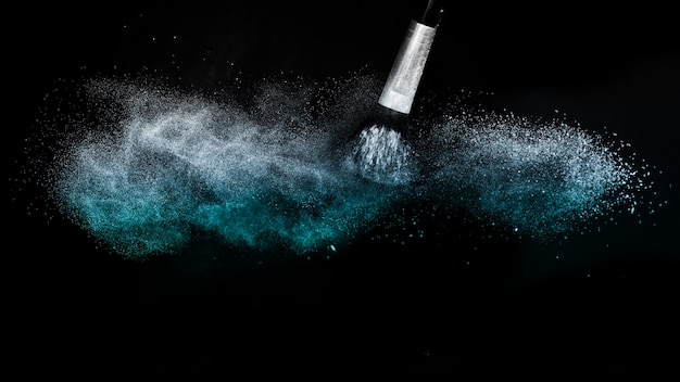 Cosmetic brush with blue cosmetic powder spreading