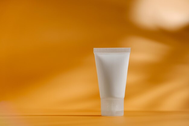 Cosmetic container mock up Moisturizer tube on minimalistic orange background