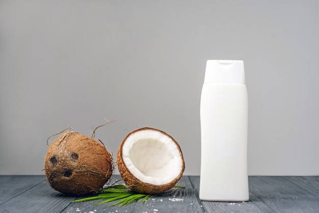 cosmetic and cream bottle with open coconut