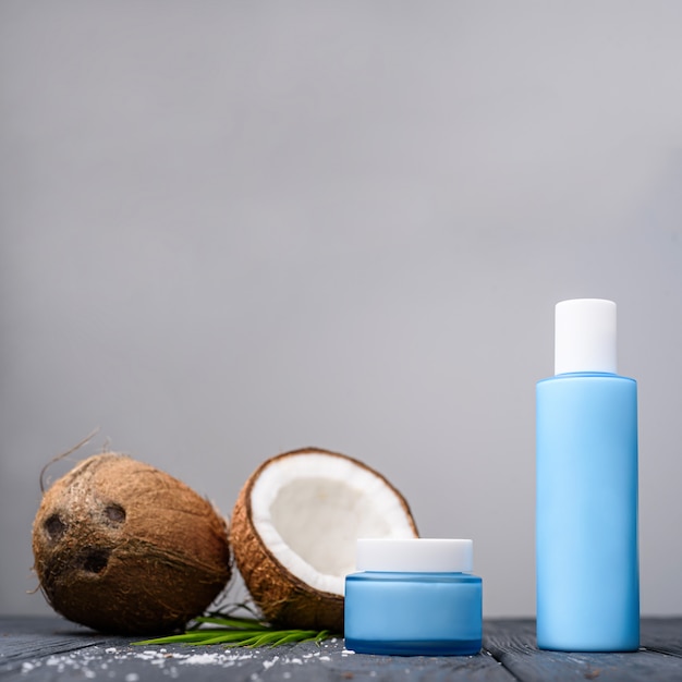 cosmetic and cream bottle with open coconut