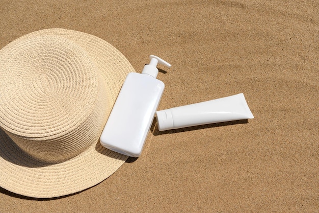 Cosmetic cream on a straw hat on the sand Skin care