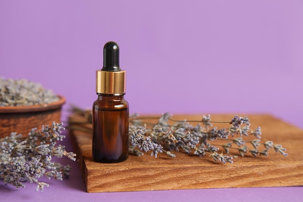 Cosmetic glass bottle for essential oil Lavender Mockup Lavender Cosmetics Podium on violet background