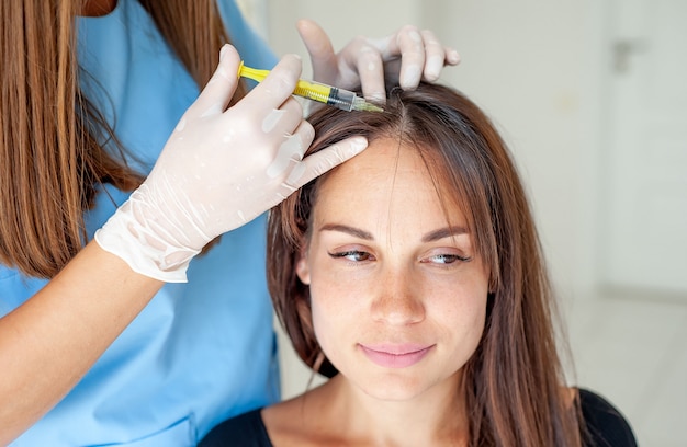 cosmetic injection to the head in the clinic