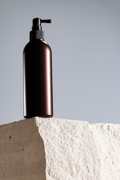 Cosmetic jar on gray cinder block close up photo