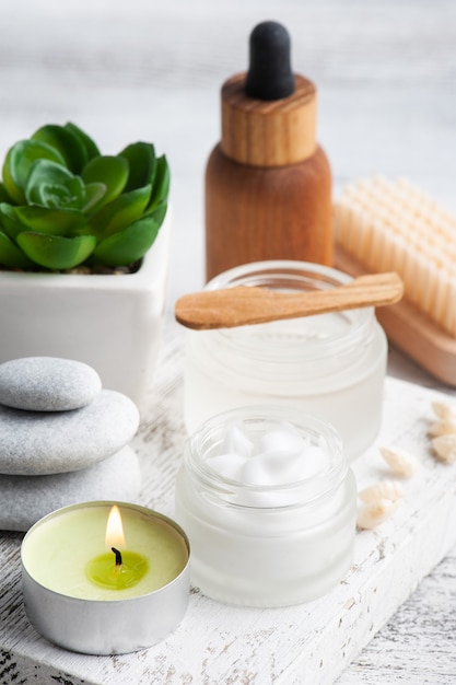 Vaso cosmetico con crema, lozione idratante per il corpo o maschera su fondo in legno. spa biologica naturale con packaging ecologico