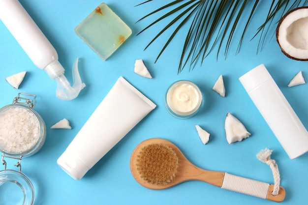 Cosmetic jars and coconut on the table closeup and place for text