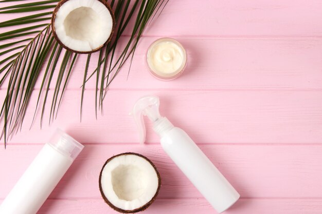 Cosmetic jars and coconut on the table closeup and place for text