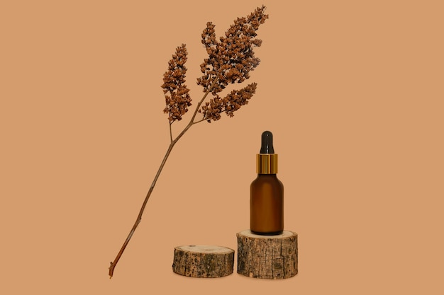 Cosmetic lotion on a wooden podium Dried flower branch On a beige background