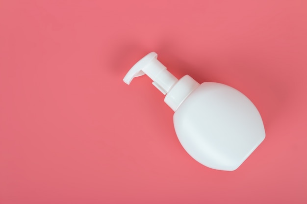 Cosmetic mock up bottle on pastel pink background