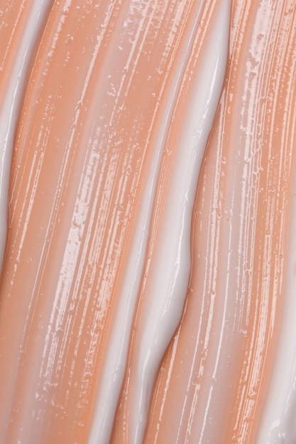 Photo cosmetic natural pastel concept. the texture of the liquid cream on a beige background.