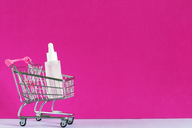 Cosmetic online shopping e-commerce concept. Serum bottle, hyaluronic acid for skin care in shopping