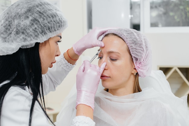 cosmetic procedure for biorevitalization and removal of wrinkles for a young beautiful girl. cosmetology.