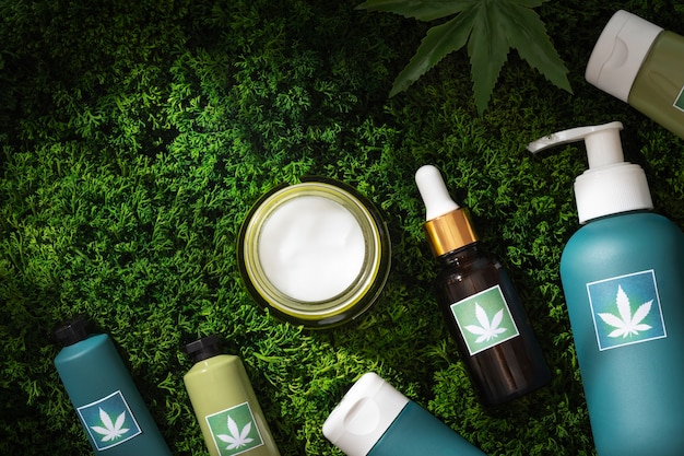 Photo cosmetic product packaging with marijuana leaf motif