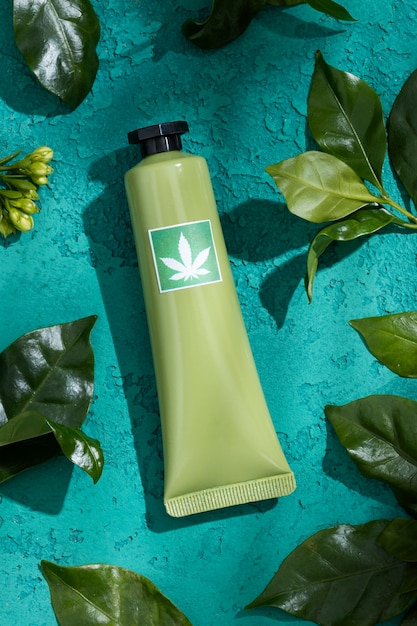 Photo cosmetic product packaging with marijuana leaf motif