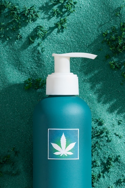 Photo cosmetic product packaging with marijuana leaf motif