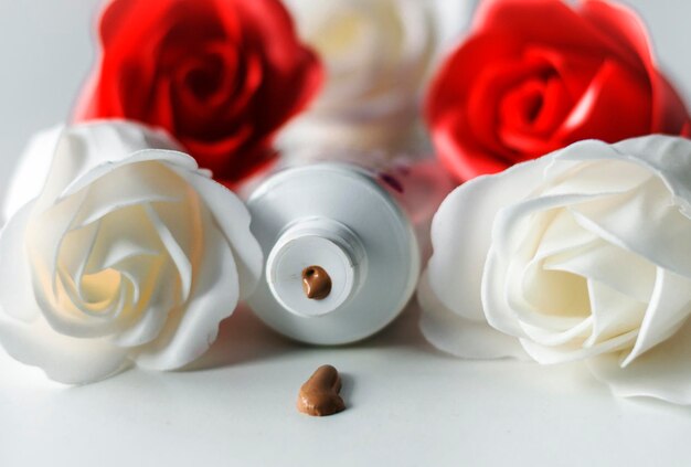 cosmetic product in a tube on a bong background with roses