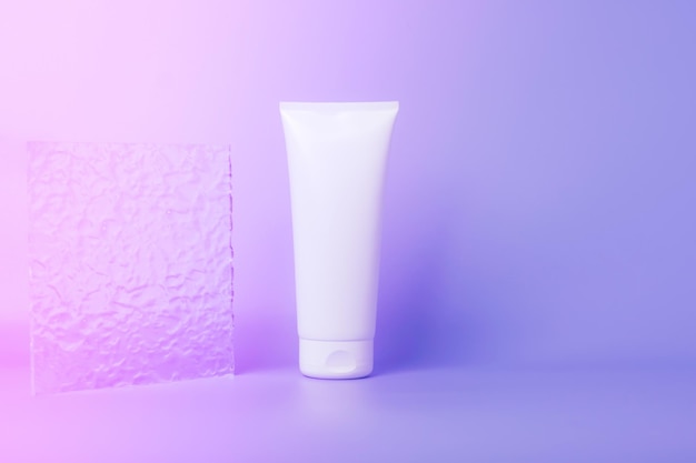 Cosmetic product in a tube white container purple background Shampoo hand cream toothpaste white packaging