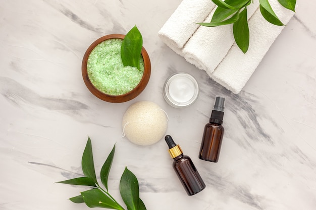 cosmetic product with tea tree essential oil. fresh tea tree leaves, salt and oil