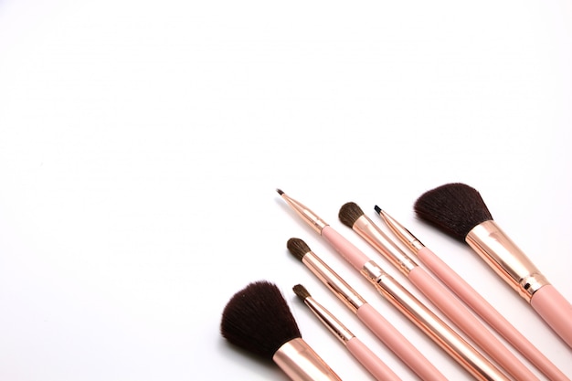 Photo cosmetic set of make up brush on pink color flat-lay isolated on a white background