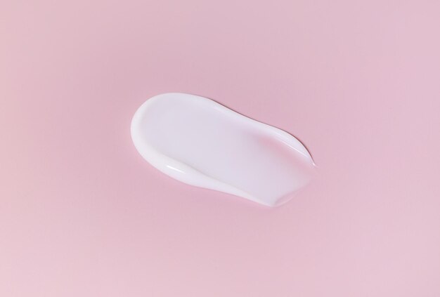 Cosmetic smears cream texture on pastel pink background