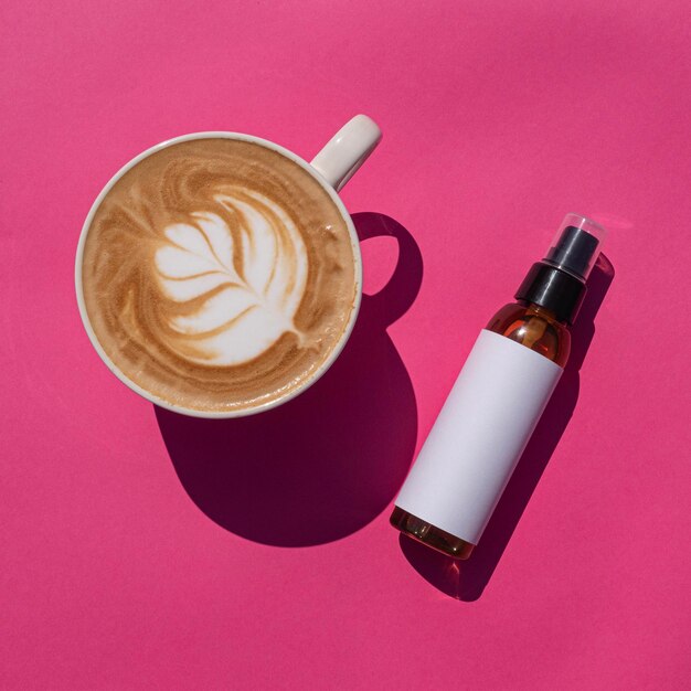 Cosmetic spray bottle mockup with latte on pink background