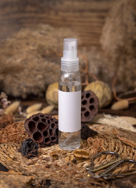 Cosmetic spray bottle on wood near natural boho decorations close up Label Mockup