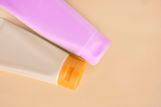 Cosmetic tubes on beige background