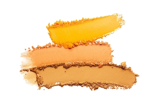 Cosmetic yellow camel orange smeared eye shadow swatch isolated on white background