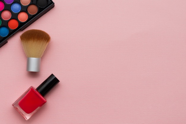 Cosmetica op een roze achtergrond met ruimte voor tekst