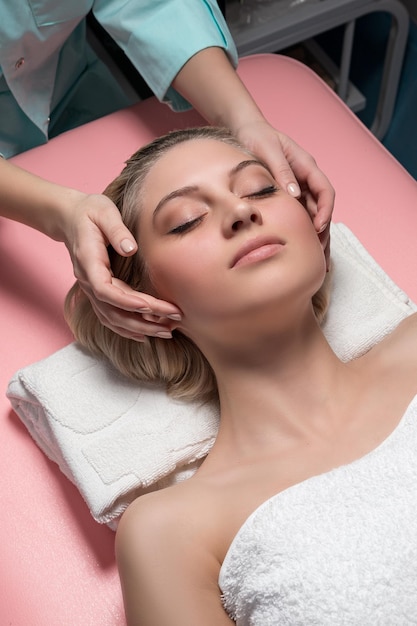 Cosmetician doing receiving facial massage