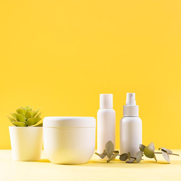 Cosmetics assortment with yellow background