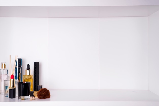 Cosmetics in bathroom on a white bathroom shelf