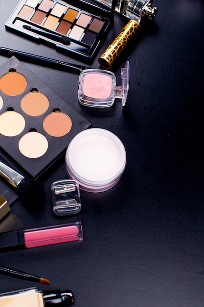 Cosmetics on dark background, closeup