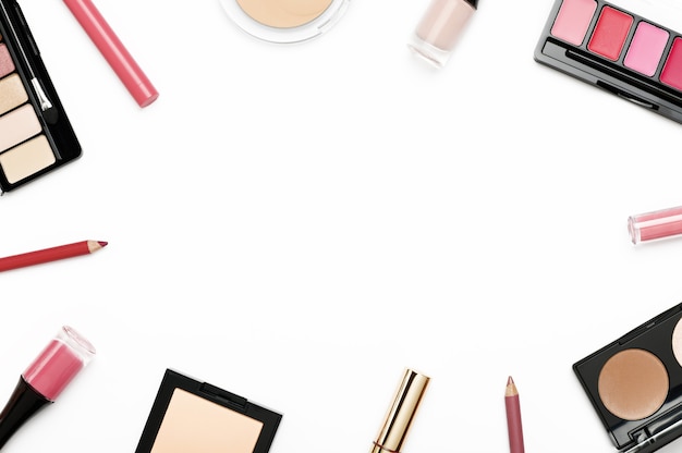 Cosmetics from above border on white background