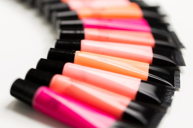 cosmetics, make up and beauty concept - close up of lip gloss tubes