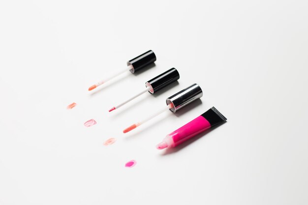 cosmetics, make up and beauty concept - close up of lip gloss tubes