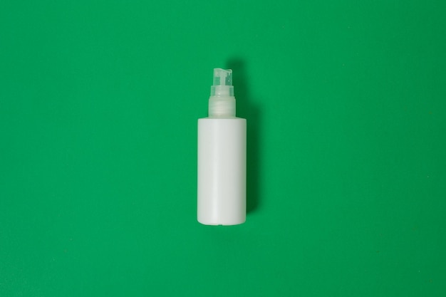 Cosmetics Moisturizer Bottle Blank plastic cosmetics bottle isolated on green background