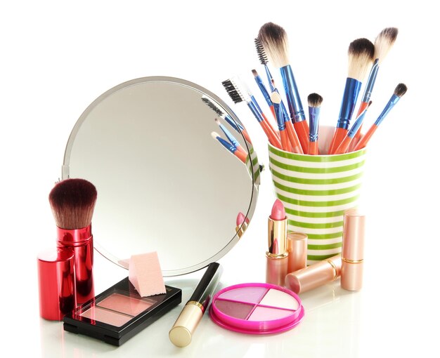 Cosmetics near mirror isolated on white