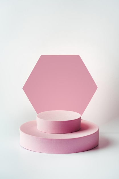 Cosmetics product advertising stand Exhibition pink podium with geometric shapes on a white color