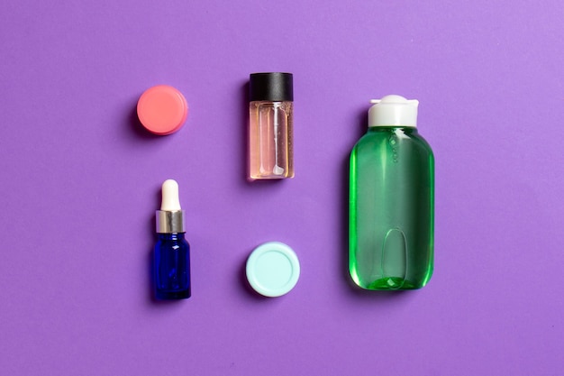 Photo cosmetics spa branding mock-up, top view with copy space. set of tubes and jars of cream flat lay on colored background.