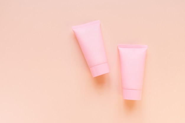 Cosmetics SPA or face and body care branding mock-up, top view on pink background, place for your design.