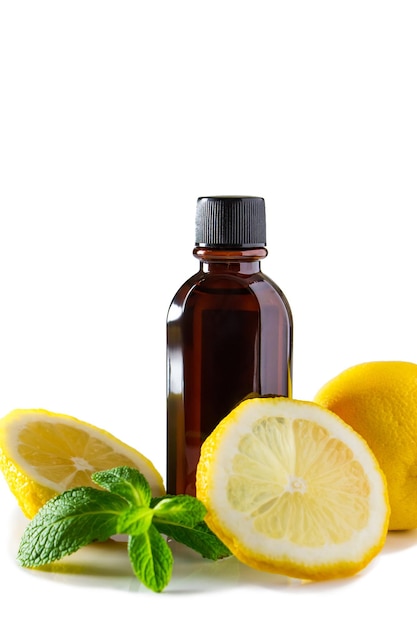 Cosmetics for spa therapy Bottle of aromatic oil with lemon and mint on white background