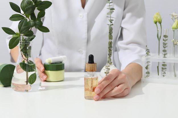 cosmetics with chemical flasks and a flower