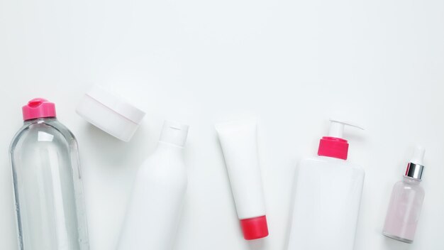 Cosmetische schoonheidsproducten op witte achtergrond Flessen en tubes met branding mock up