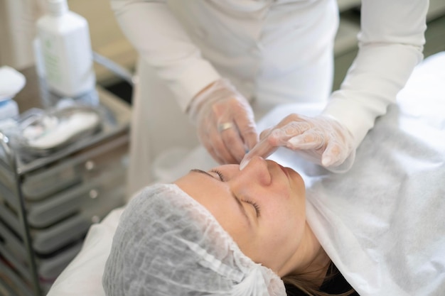 cosmetologist administers an injection into the nasolabial fold targeting signs of aging precision