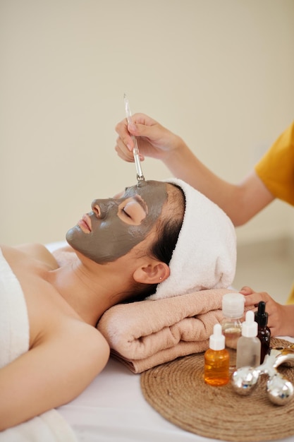 Cosmetologist Applying Clay Mask