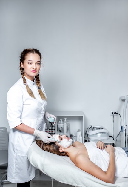 a cosmetologist-dermatologist in a cosmetic clinic.