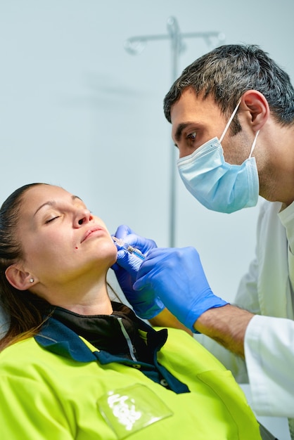 Cosmetologist making botox injection